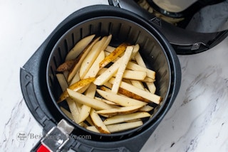 sliced potatoes in an air fryer