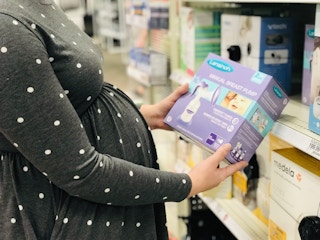 A person holding a Laniosh breast pump.