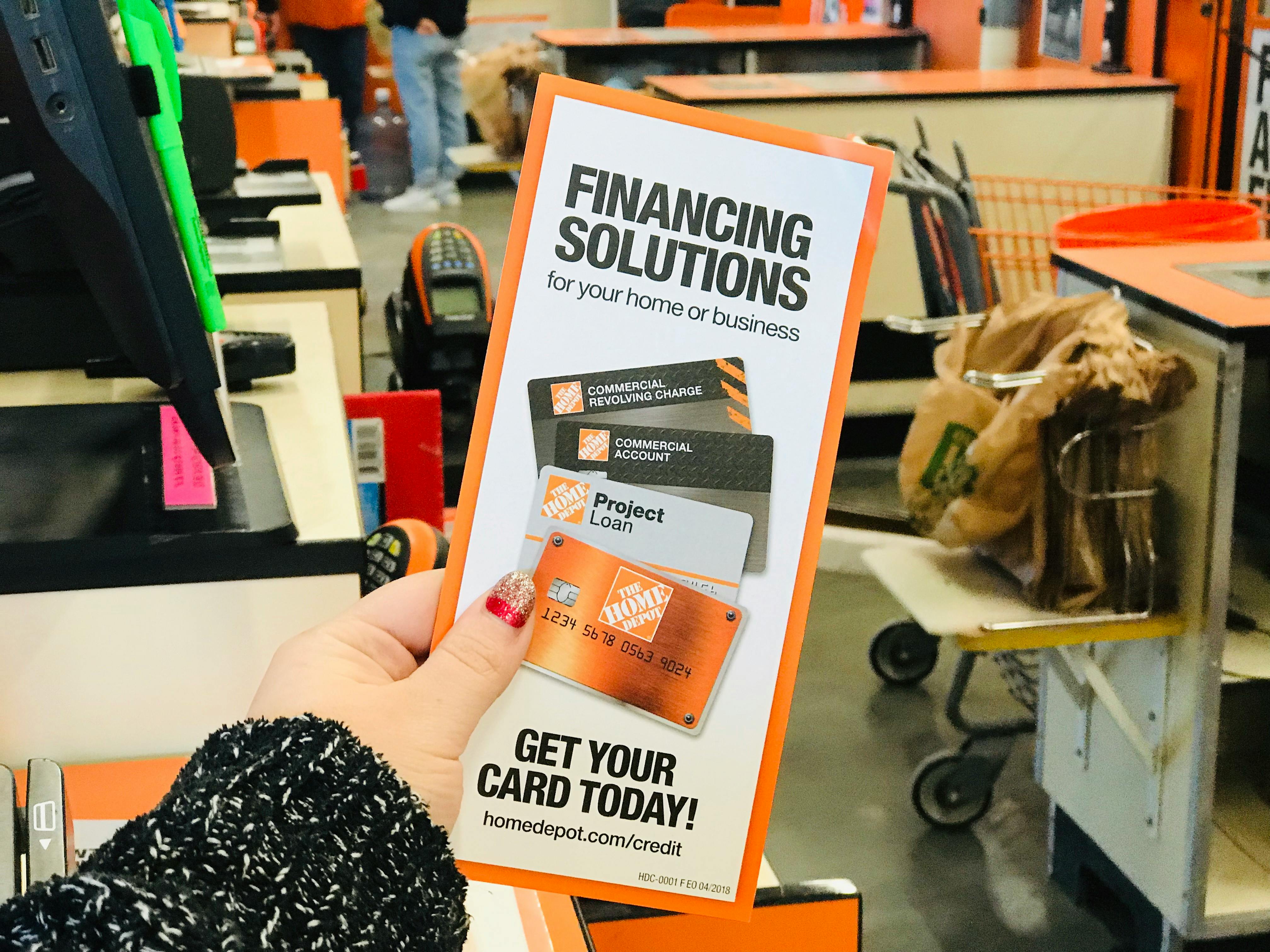 Person holding a Home Depot credit card application