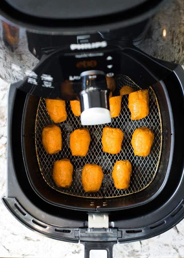 a batch of sweet potato tots in an air fryer