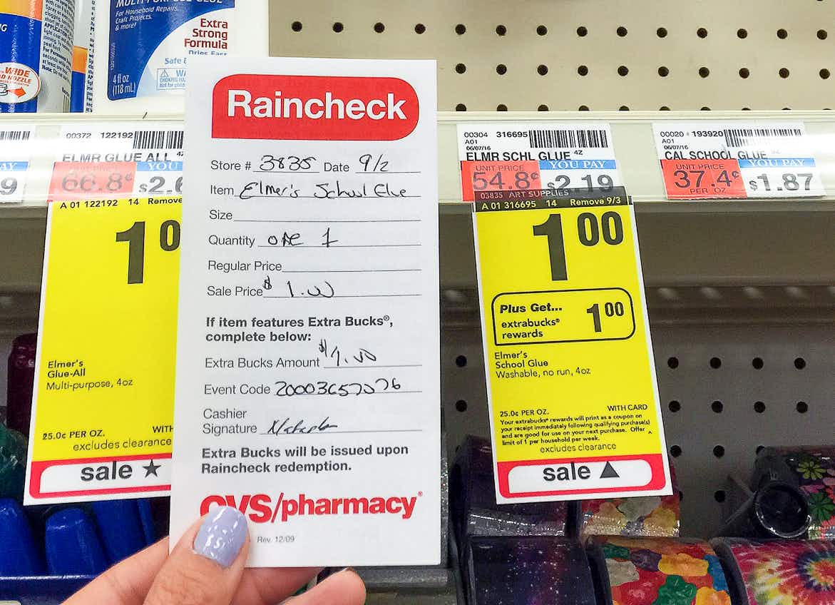 Someone holding up a CVS Raincheck slip for a sale on a sold out product