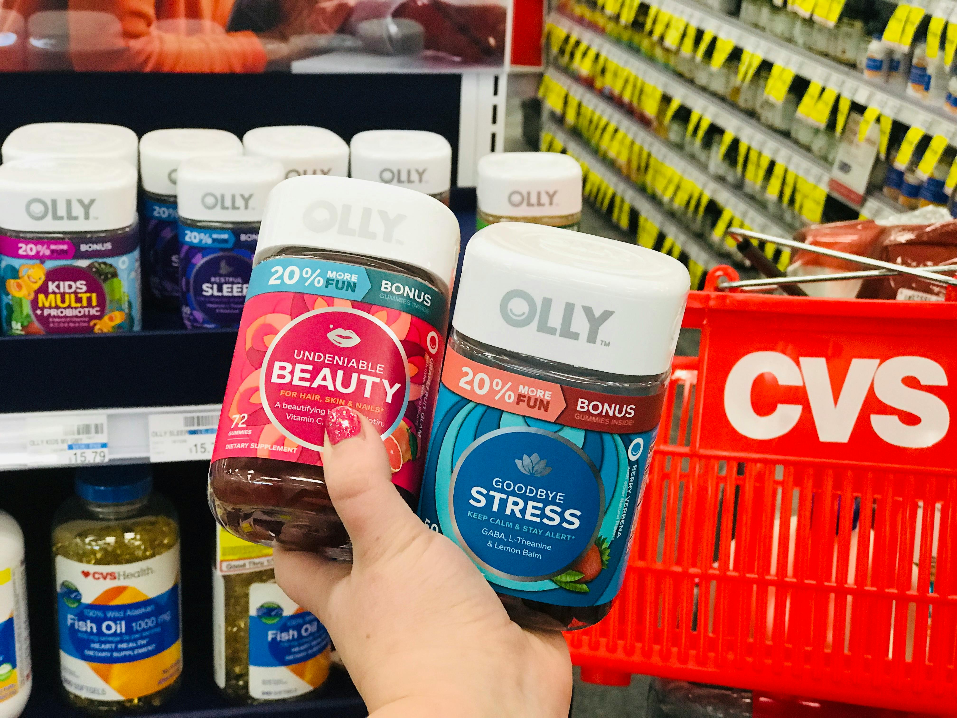 someone holding olly vitamins at cvs