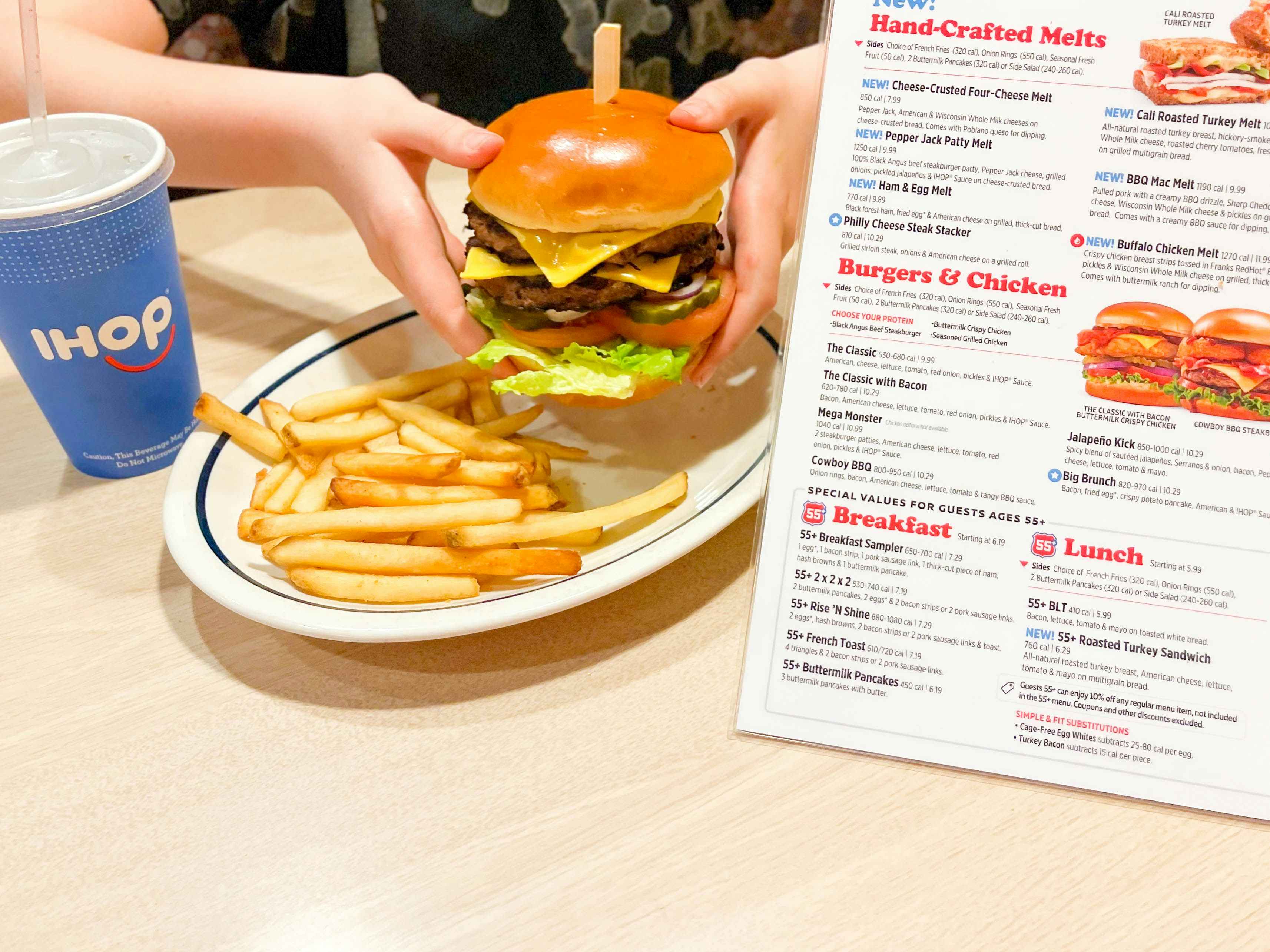 holding burger next to ihop menu