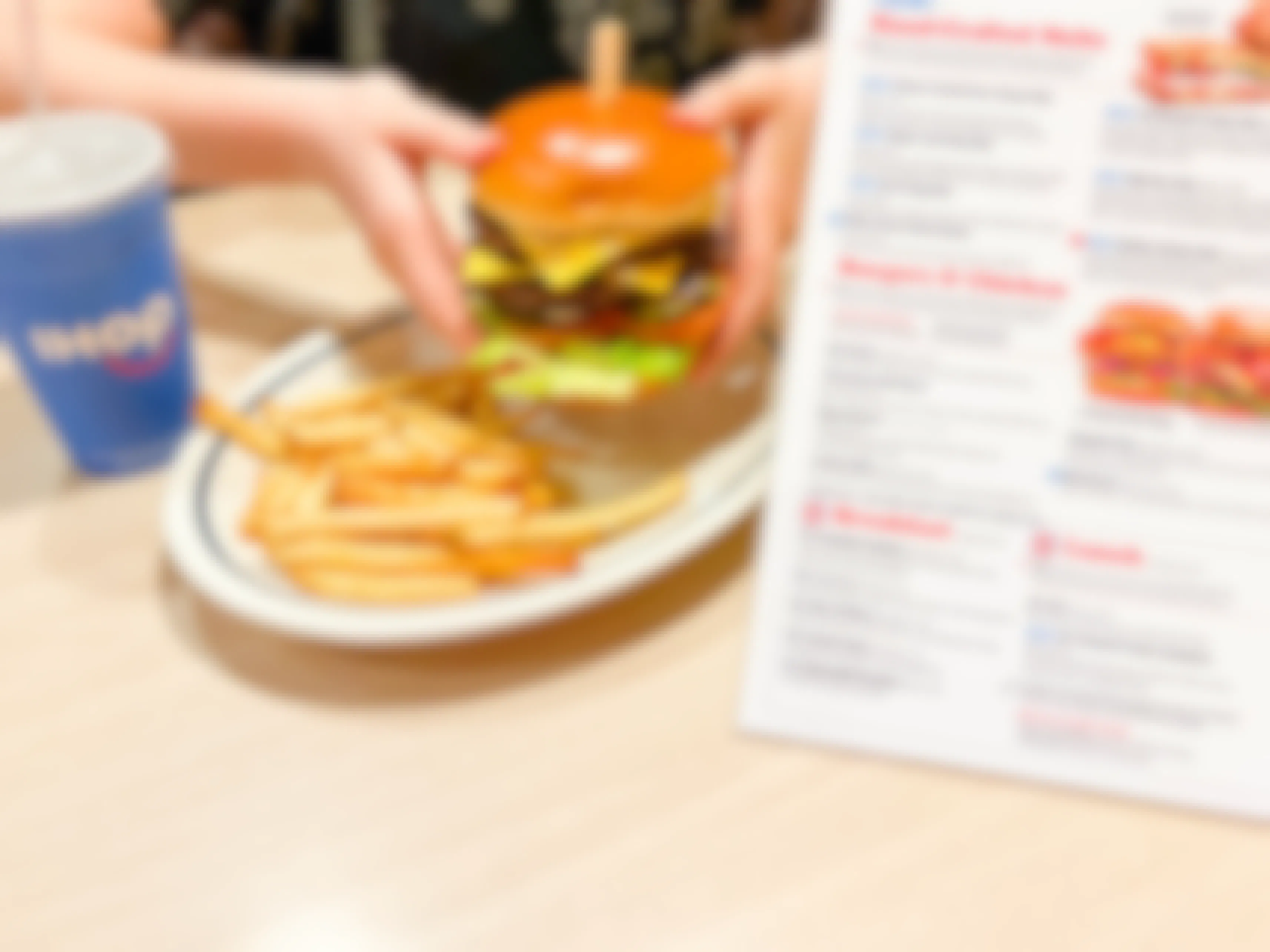 holding burger next to ihop menu