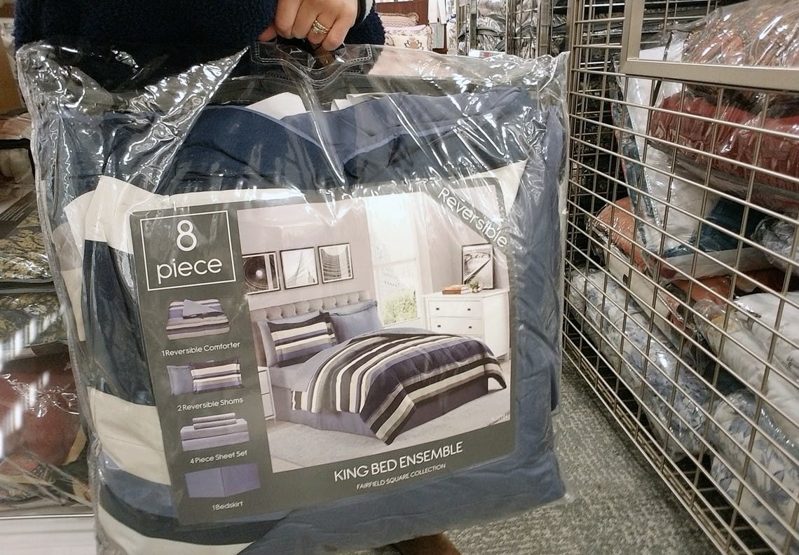 person holds 8 piece bed set at macys