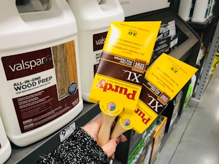 hand holding two paint brushes