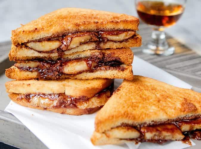 Nutella and banana sandwiches stacked on a napkin