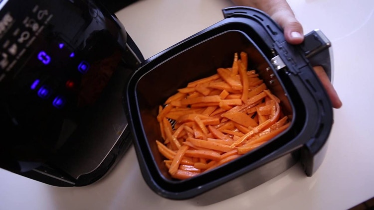 sliced sweet potatoes in an air fryer
