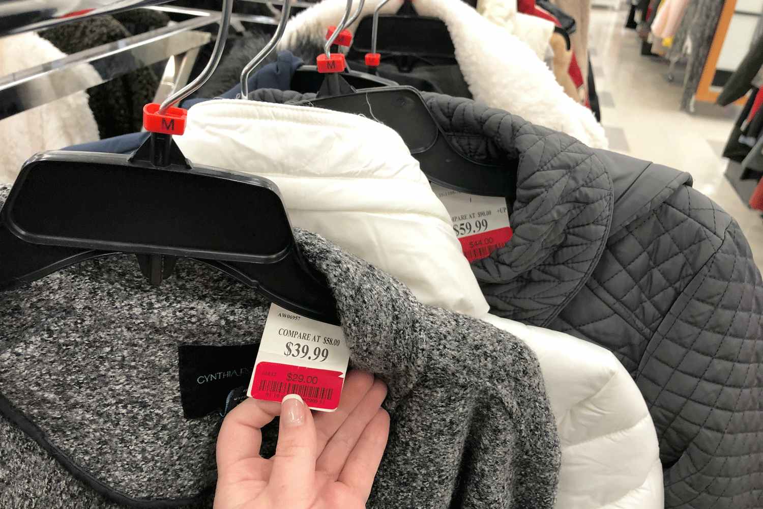 a person holding up a tj maxx clearance tag