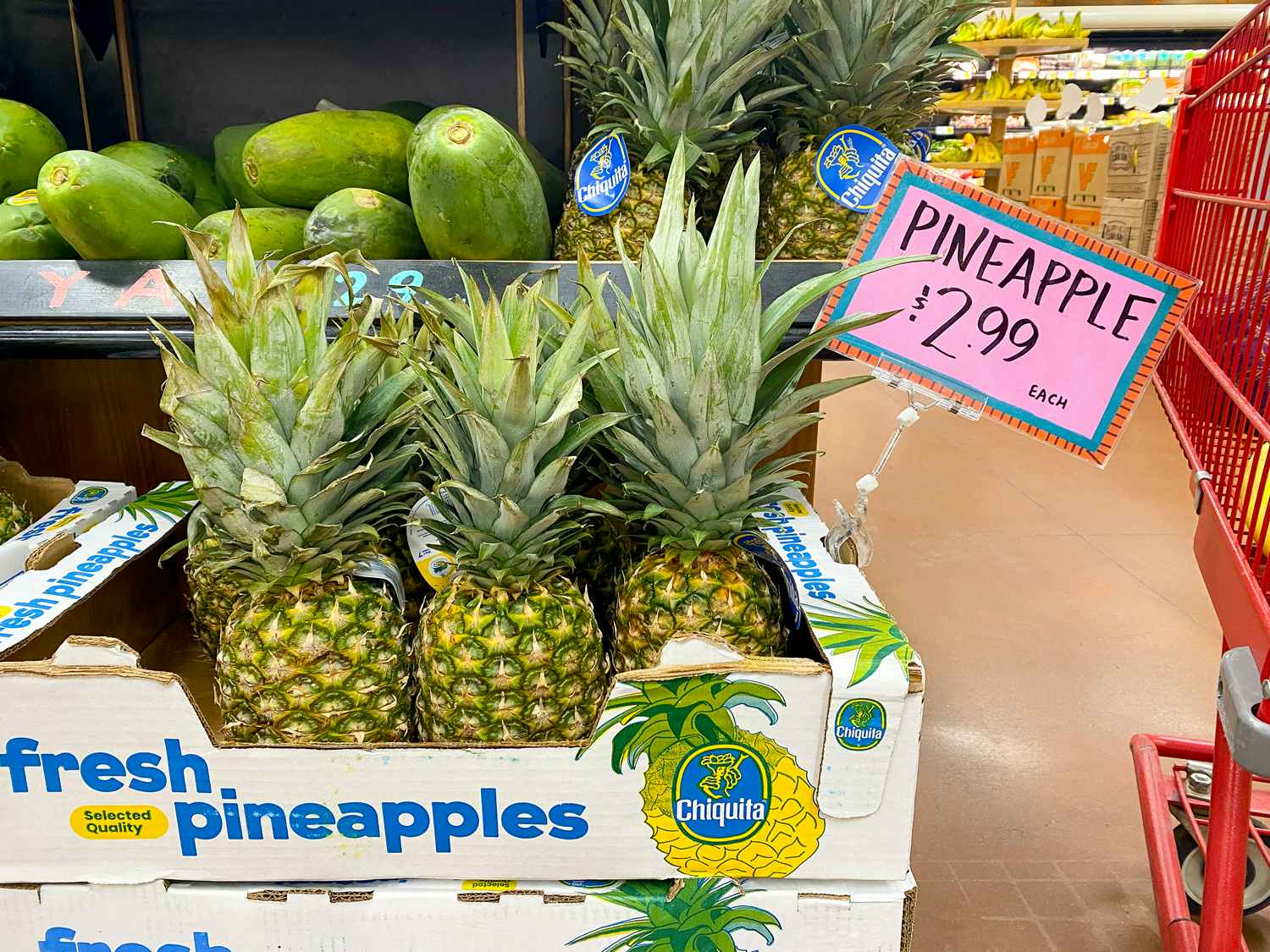 fresh pineapples with price sign in trader joes
