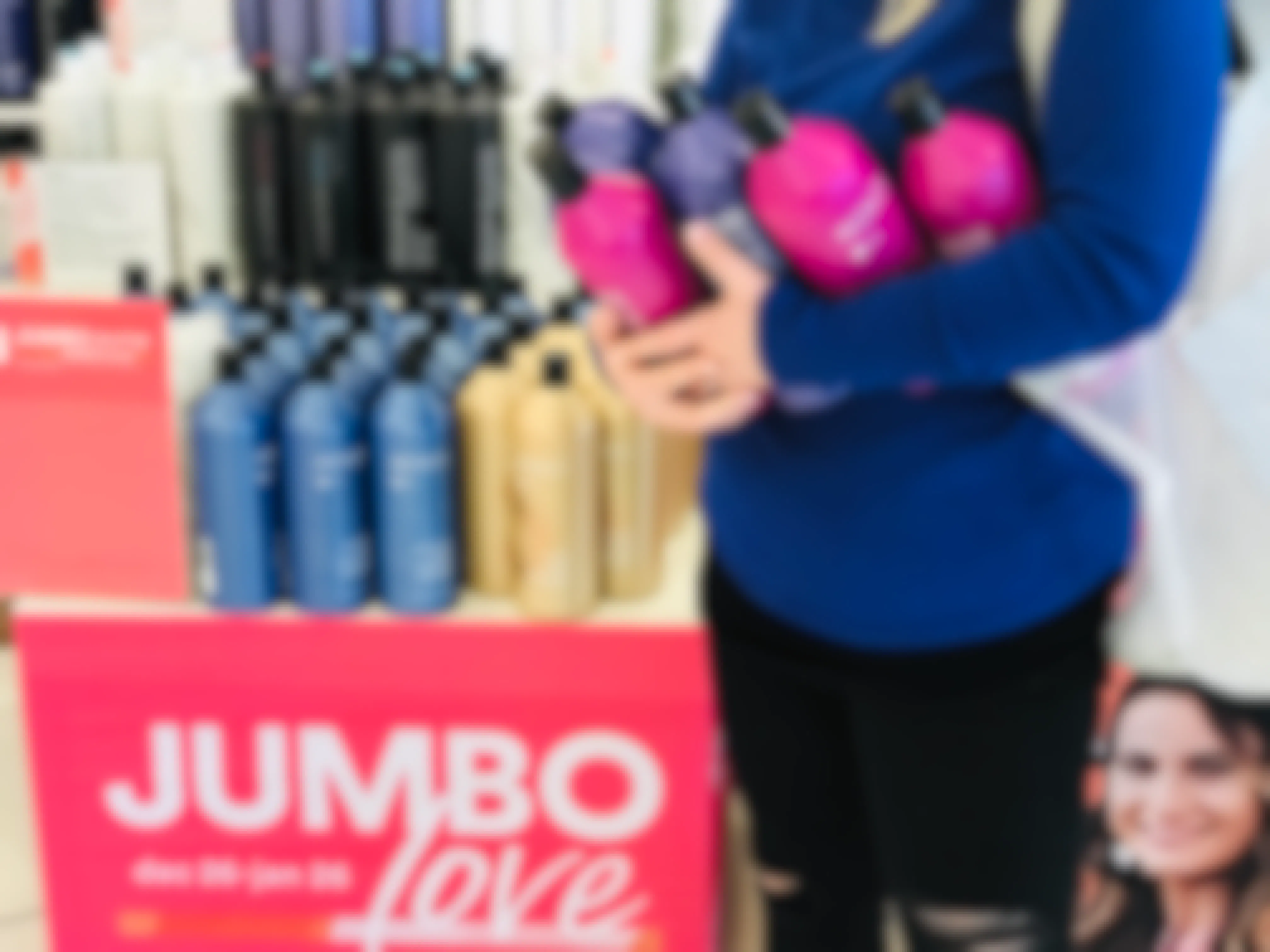 woman holds armfuls of shampoos at jumbo love at ulta