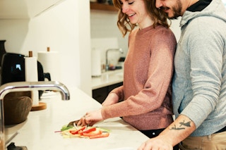 a couple making dinner together