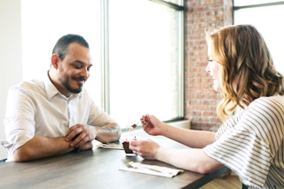a couple eating dessert at a table