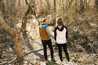 a couple hiking in the woods together