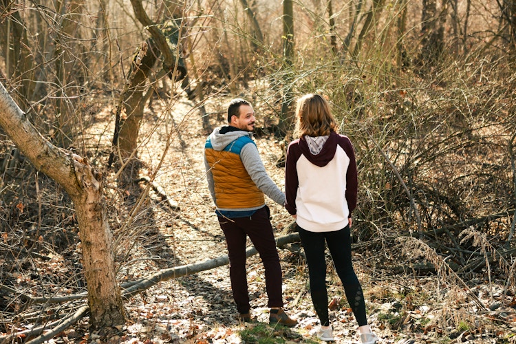 a couple hiking in the woods together 