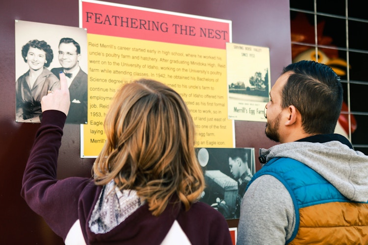 a couple looking at photos in a museum 