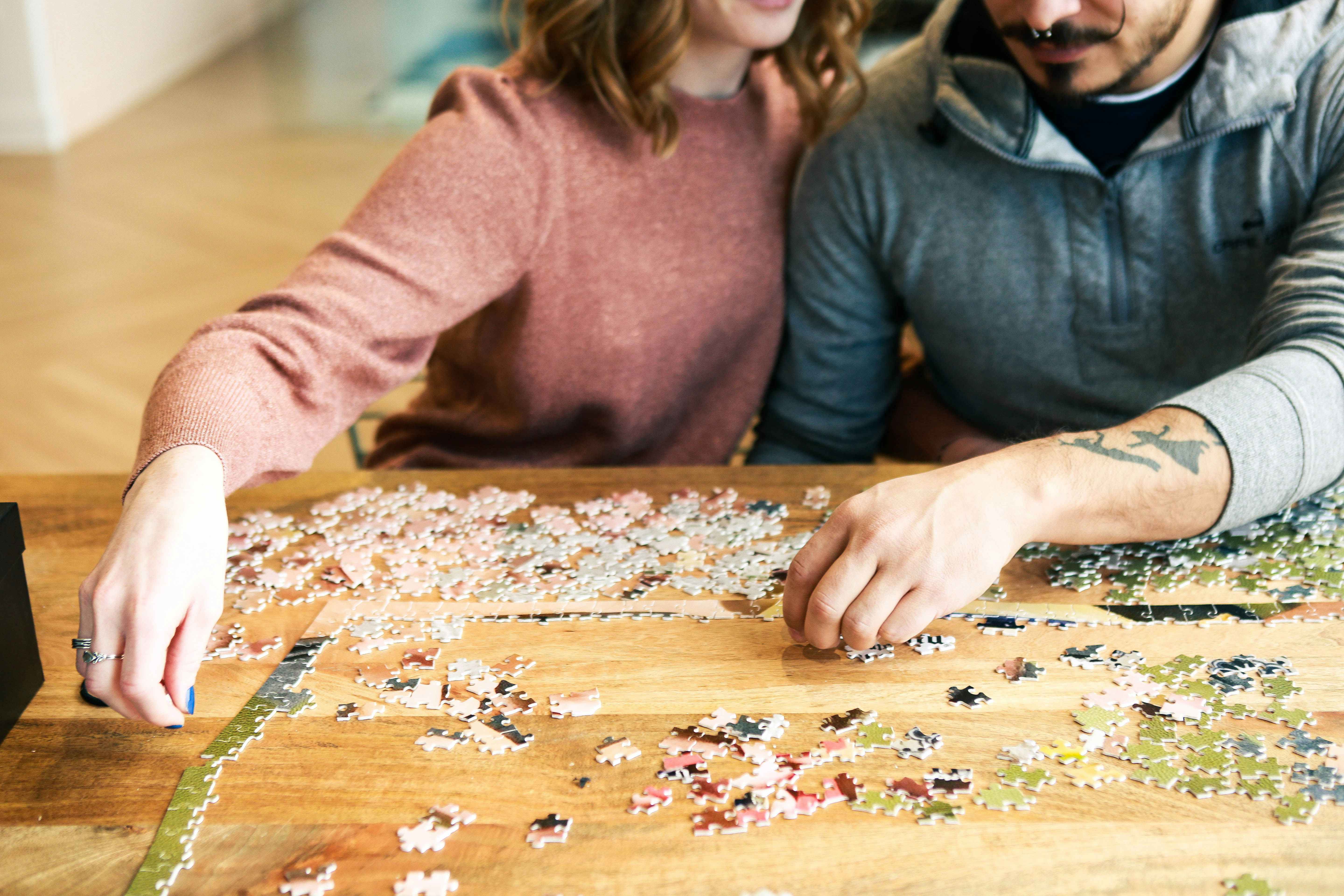 a couple working on a puzzle together 