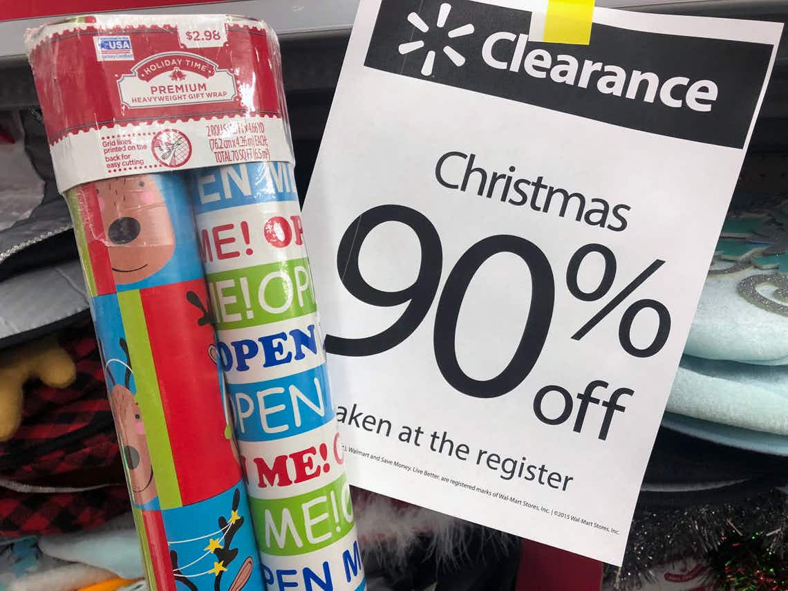 Wrapping paper in front of Walmart Clearance sign that says 90% off