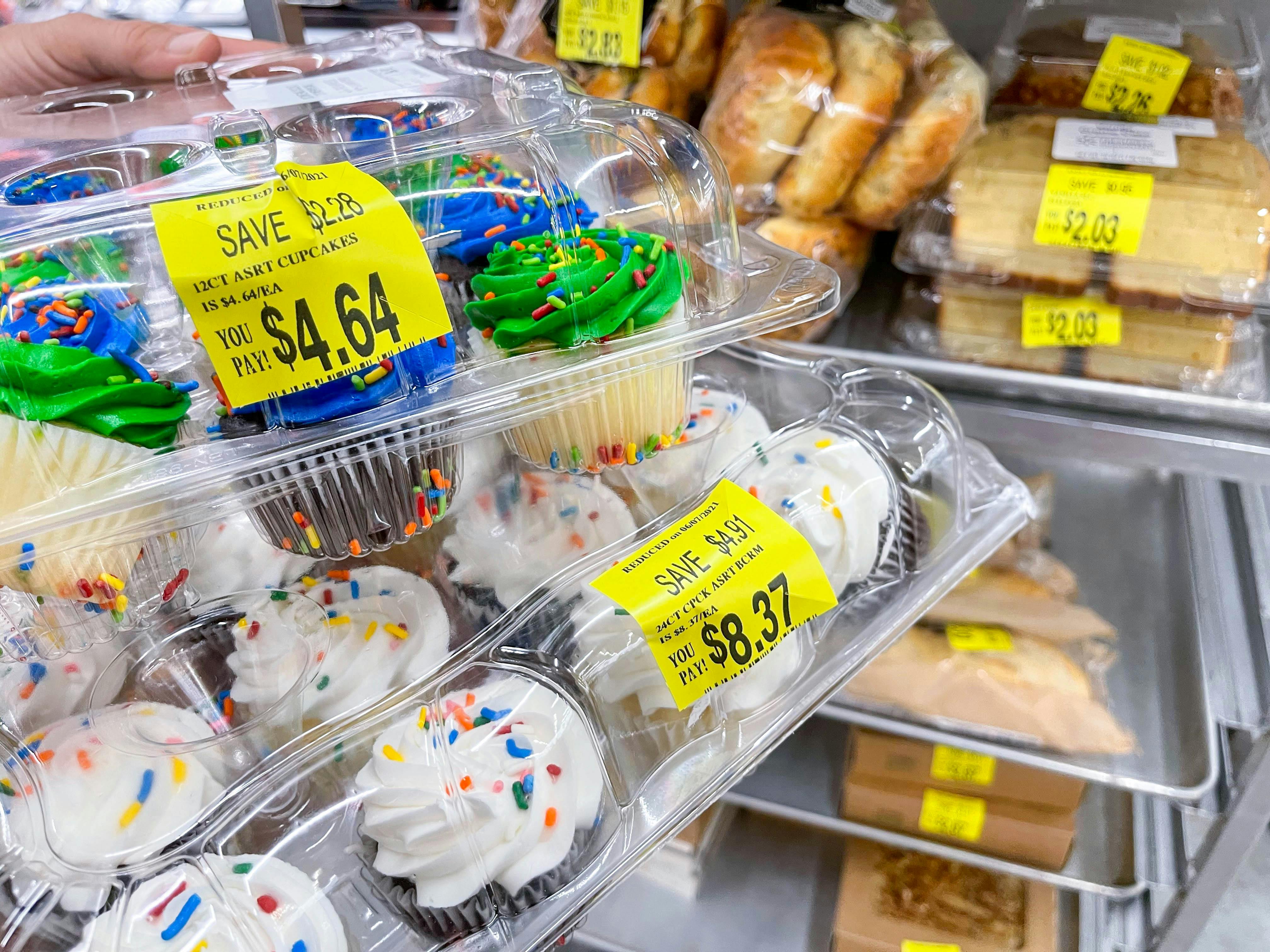 person holding packages of walmart cupcakes on clearance