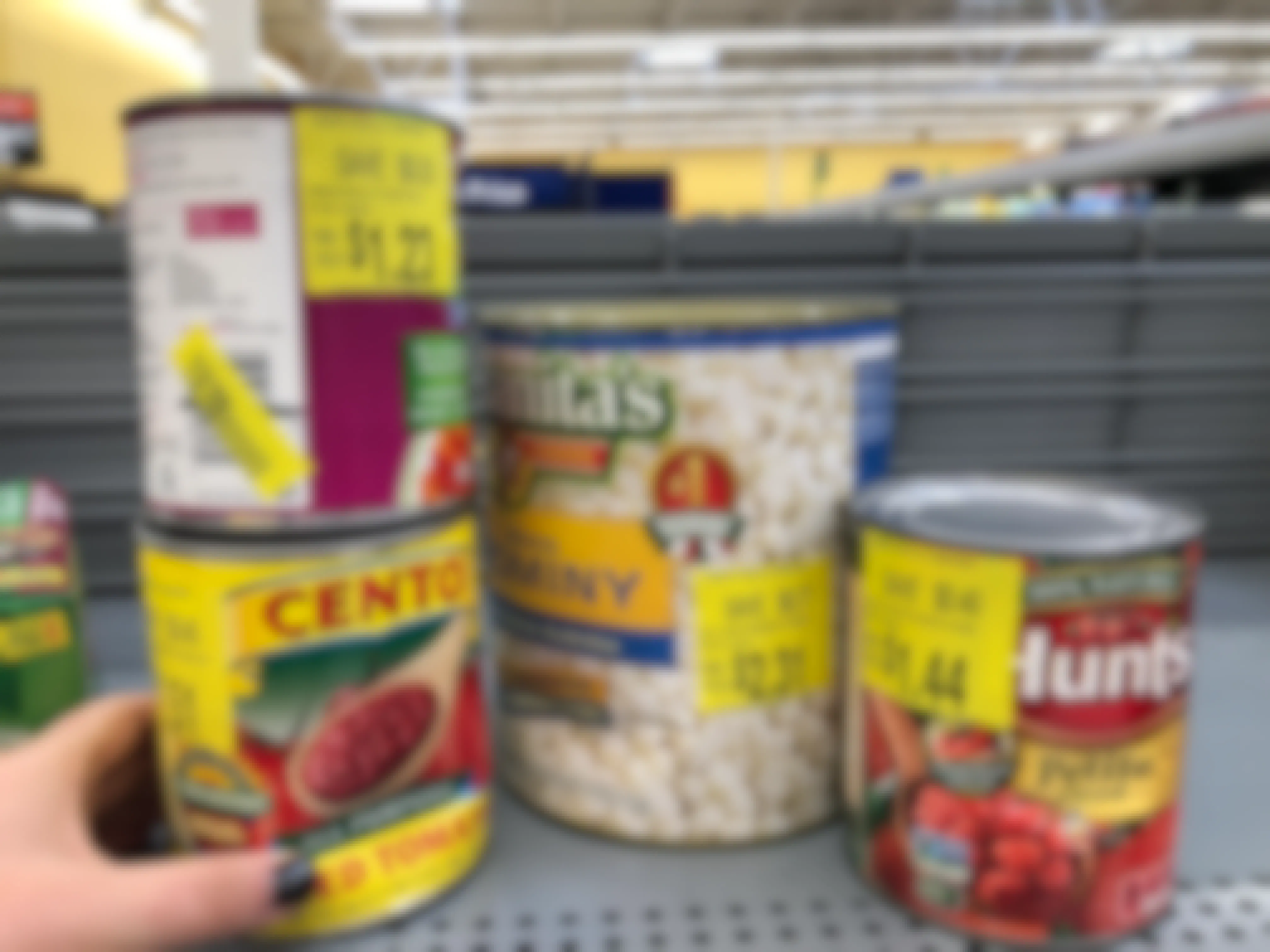 person looking at dented canned goods in walmart clearance aisle