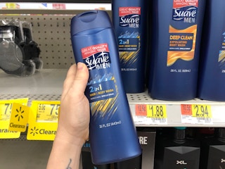 left hand holding bottle of suave men 2-in-1 hair and body wash in front of suave men shelves at walmart