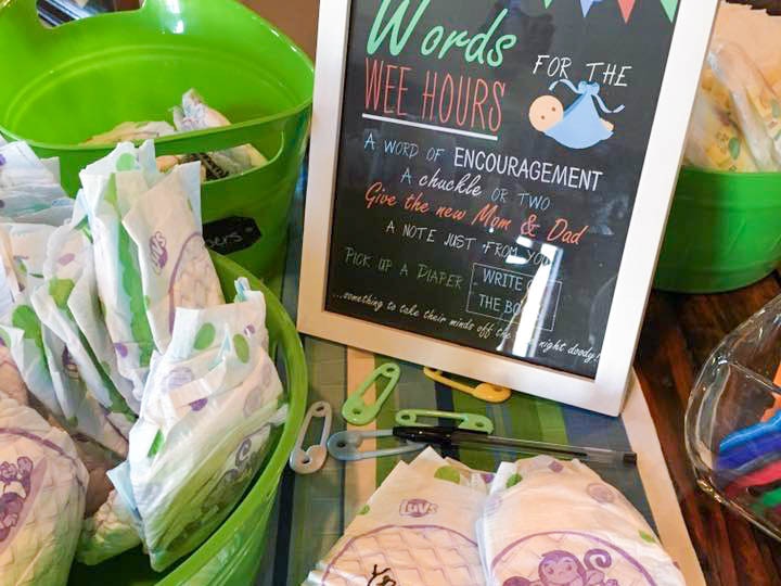 Baby diapers and a sign indicating for people to write messages to the mom and dad for late night diaper changes.