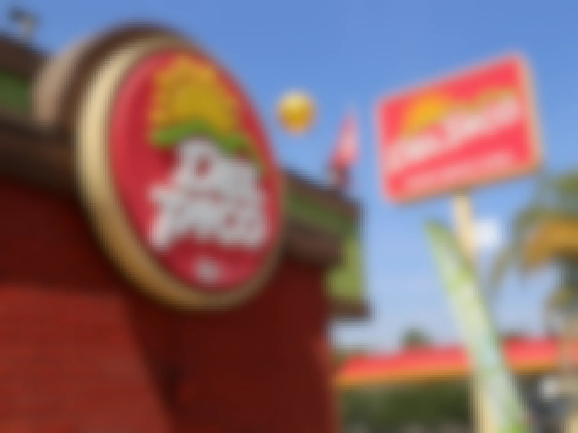 A Del Taco sign and restaurant exterior.