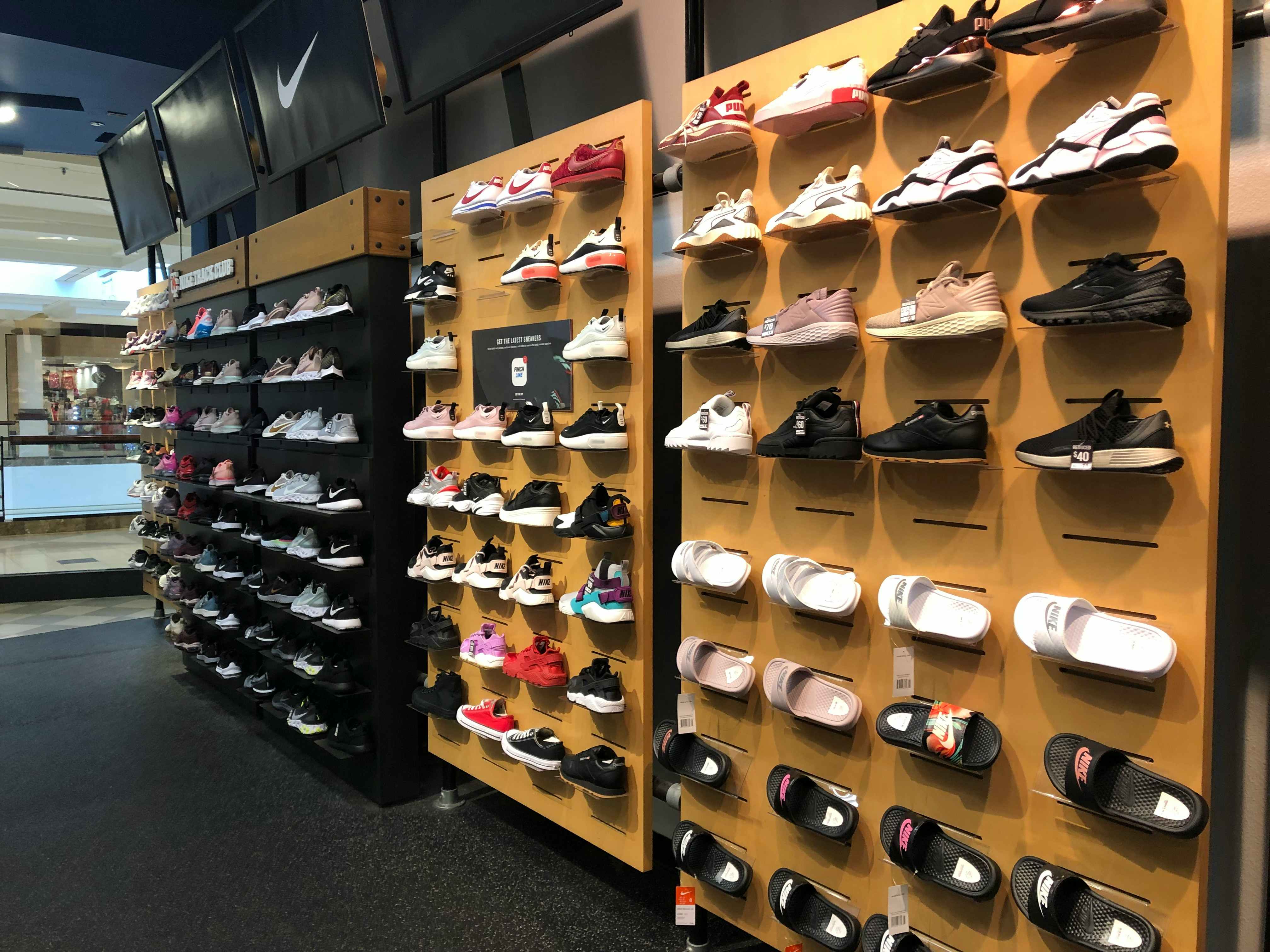 women's sneakers displayed on shelf at Finish Line store