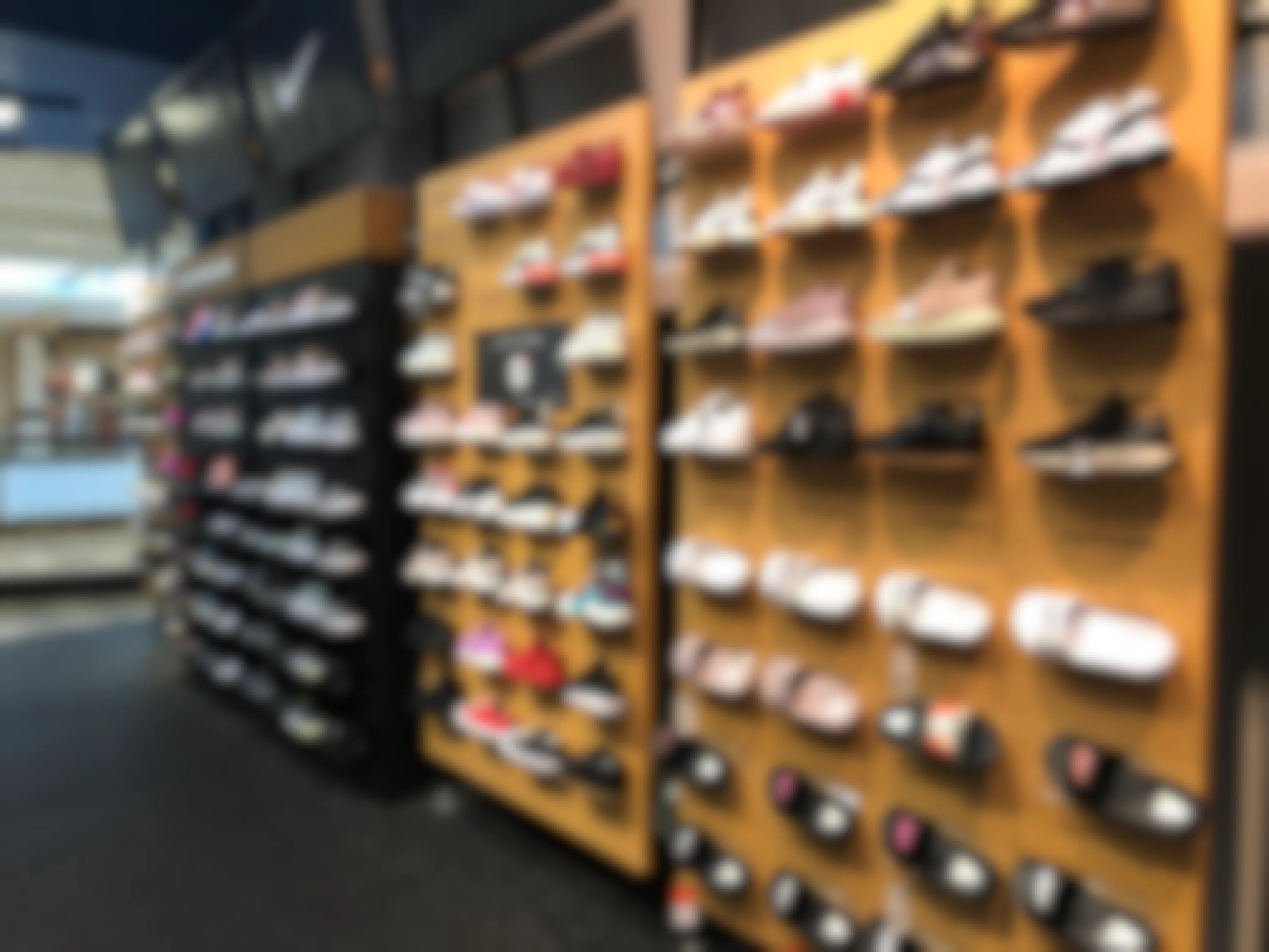 women's sneakers displayed on shelf at Finish Line store