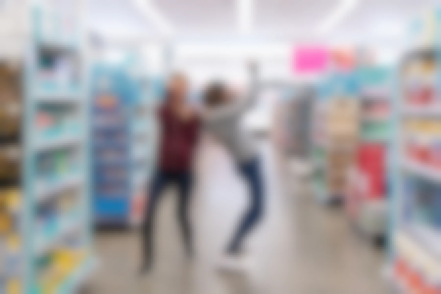 Two women celebrating in the aisles of a Walgreens store