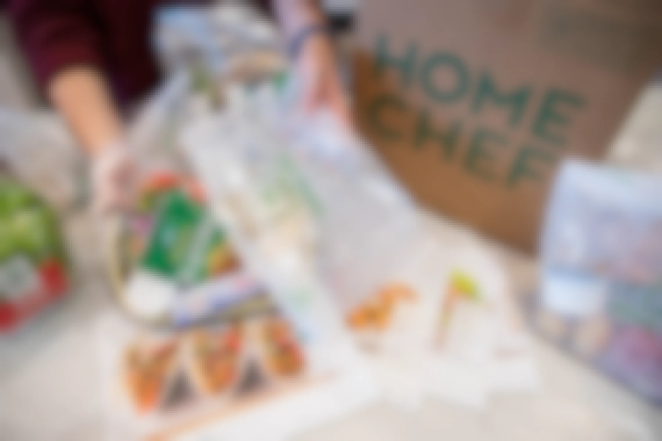 A person pulling food from a Home Shelf package showing everything individually wrapped and evenly portioned.