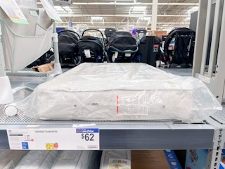 A baby crib mattress on a shelf at Walmart