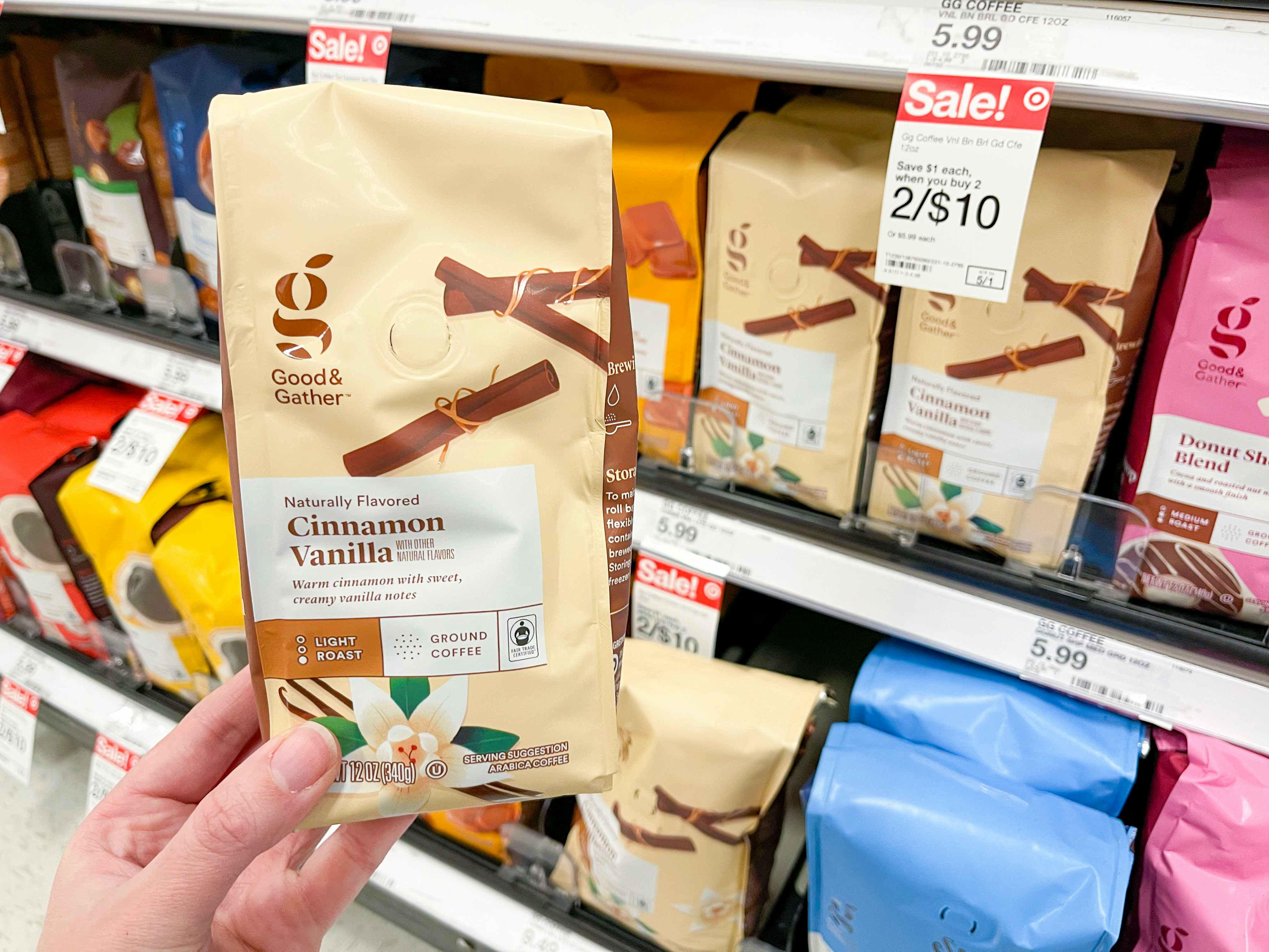 A person holding a package of Good and Gather coffee in the coffee aisle at Target