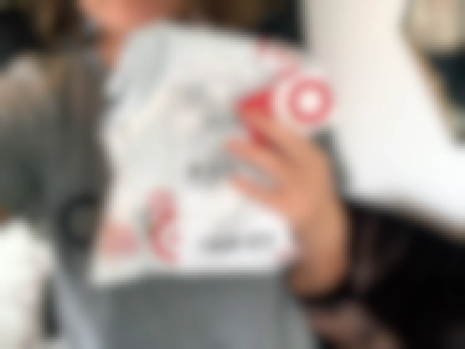 a person holding a package from target that they received in the mail with their target red card
