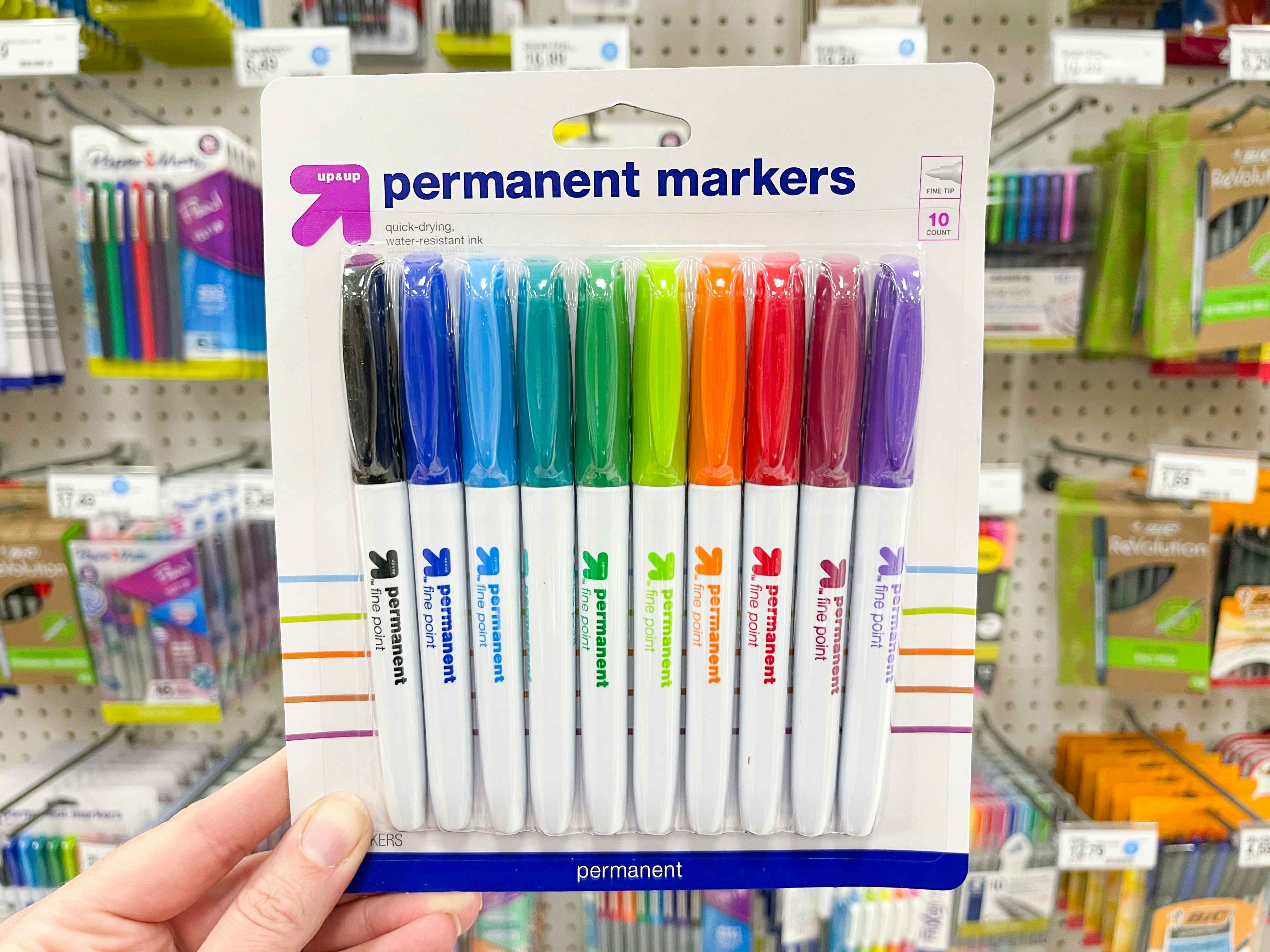 A person's hand holding up some Up&Up Permanent markers at Target.