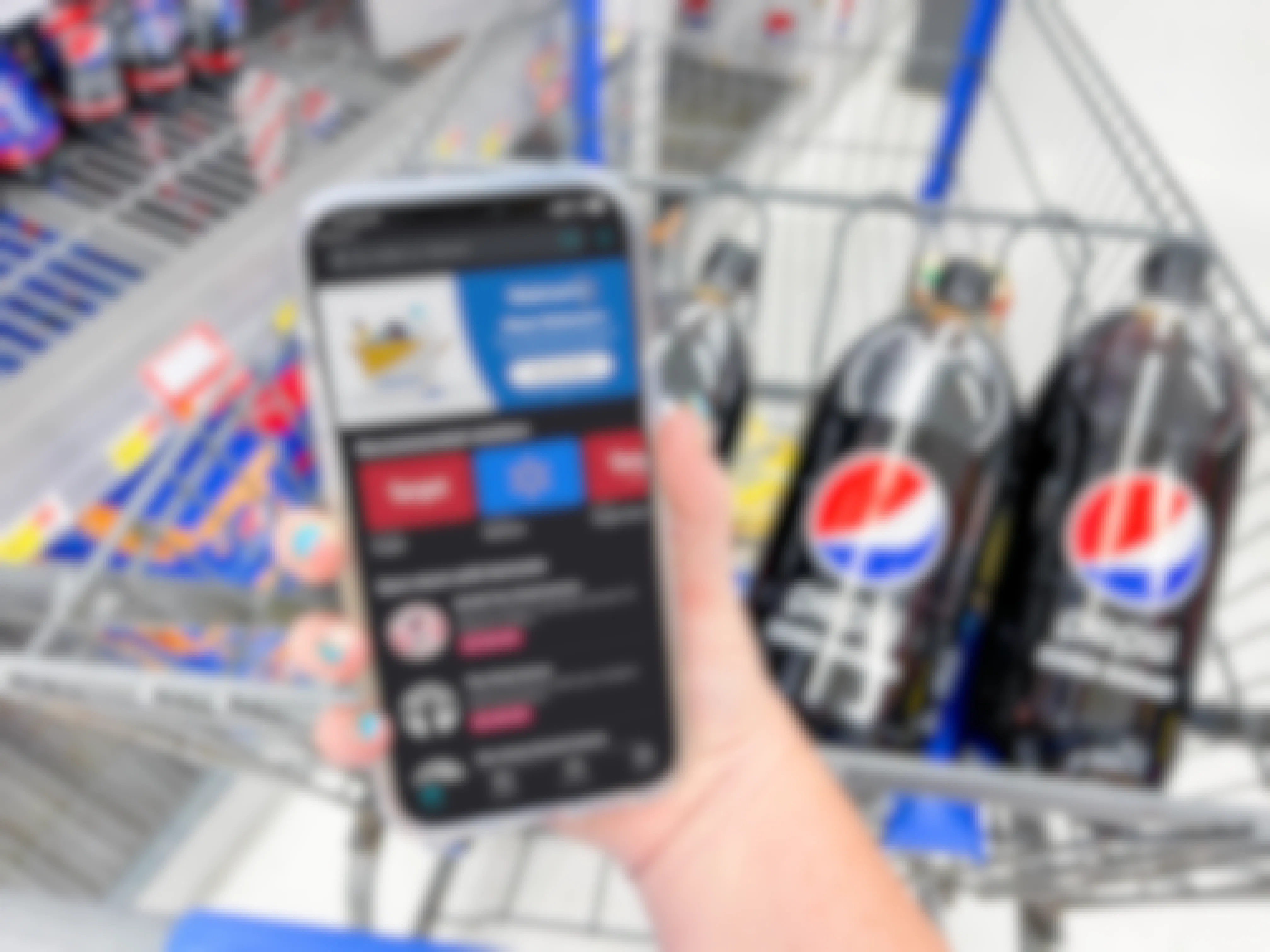 hand holding cellphone with iboota app in front of pepsi bottles in cart