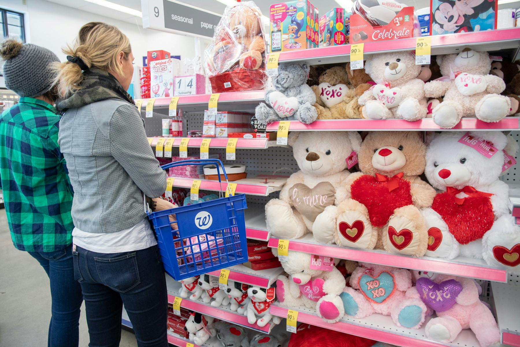 two women shopping for valentines day plush at walgreens