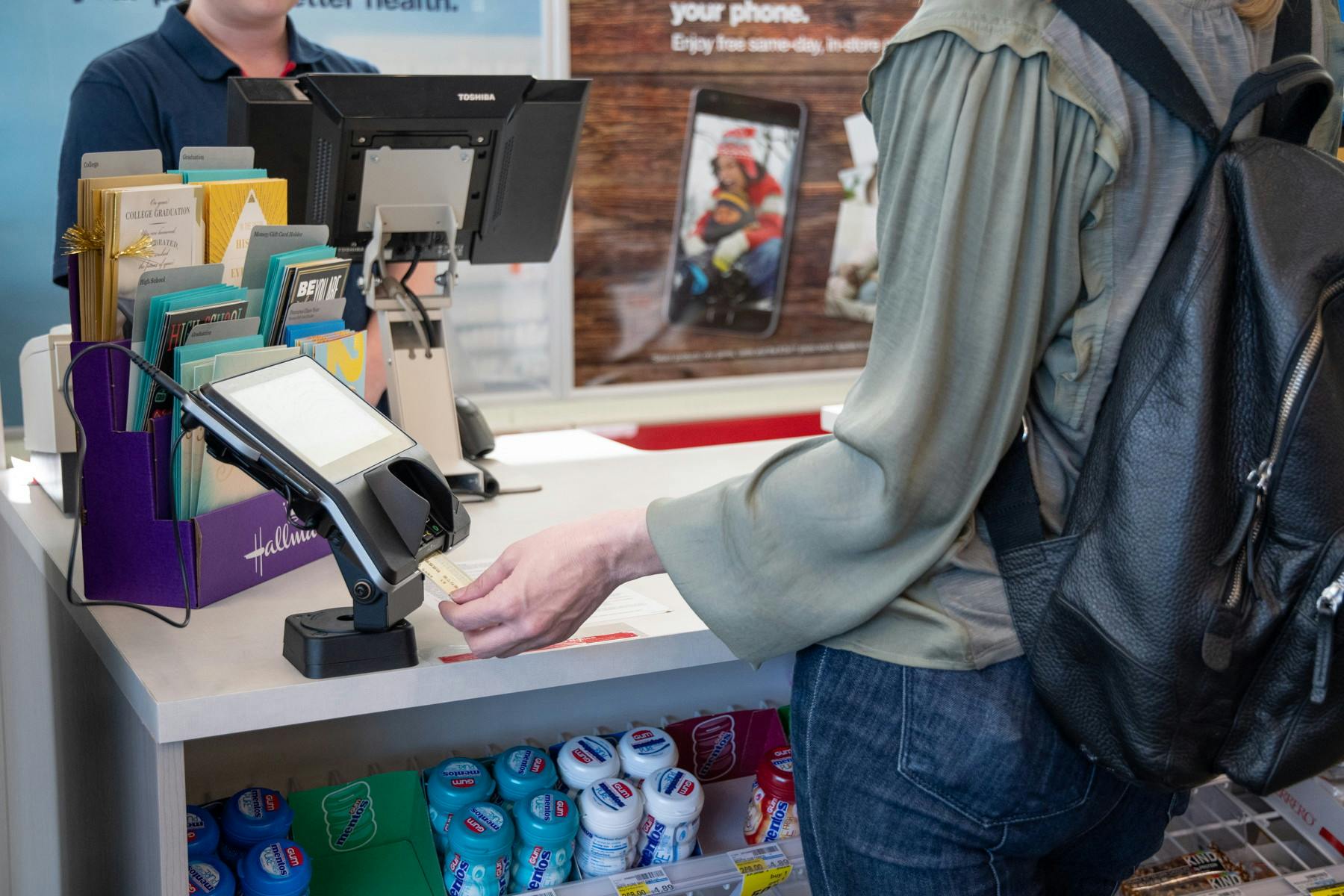 Woman inserting her card at checkout in a CVS store