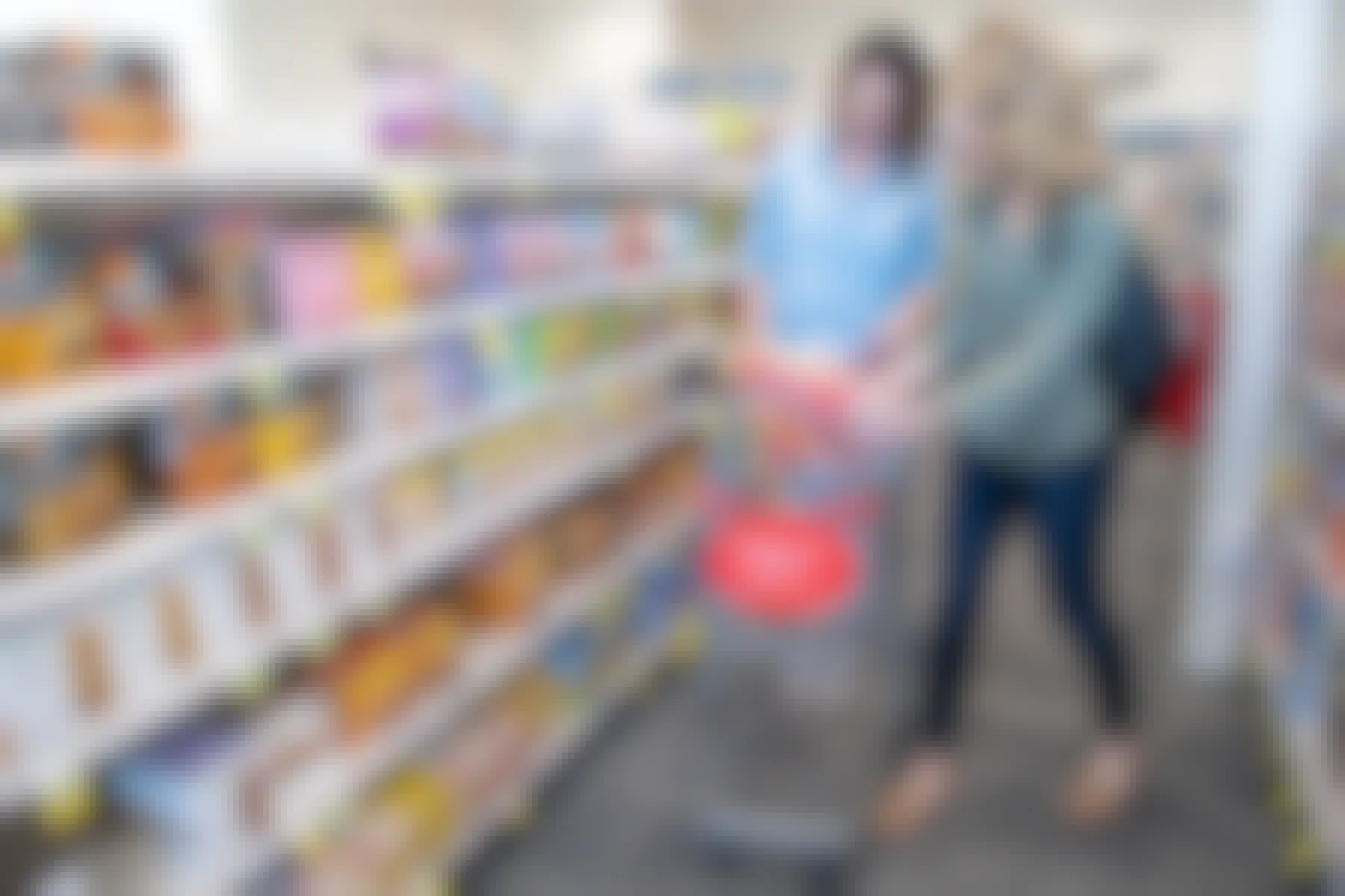 Two women look at a cereal box inside a CVS store.