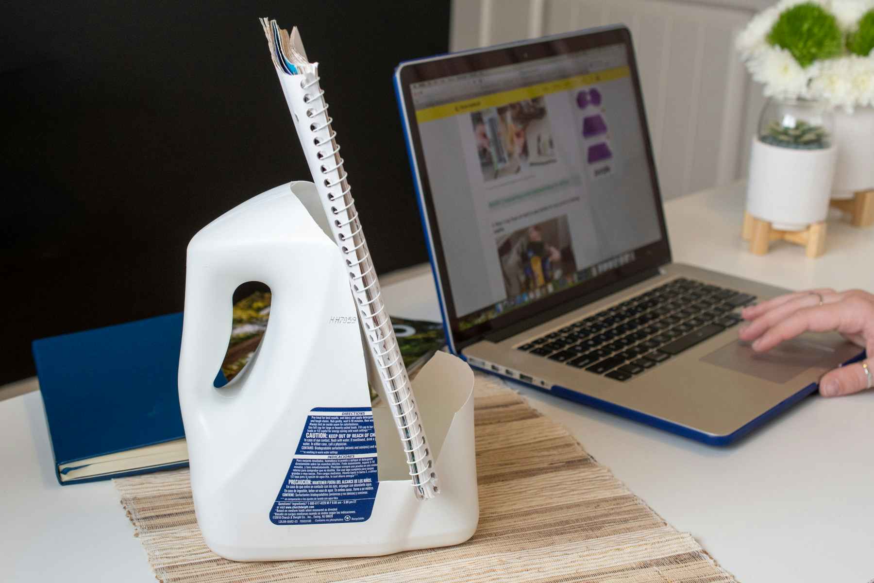 Reuse a laundry detergent bottle as a book stand.
