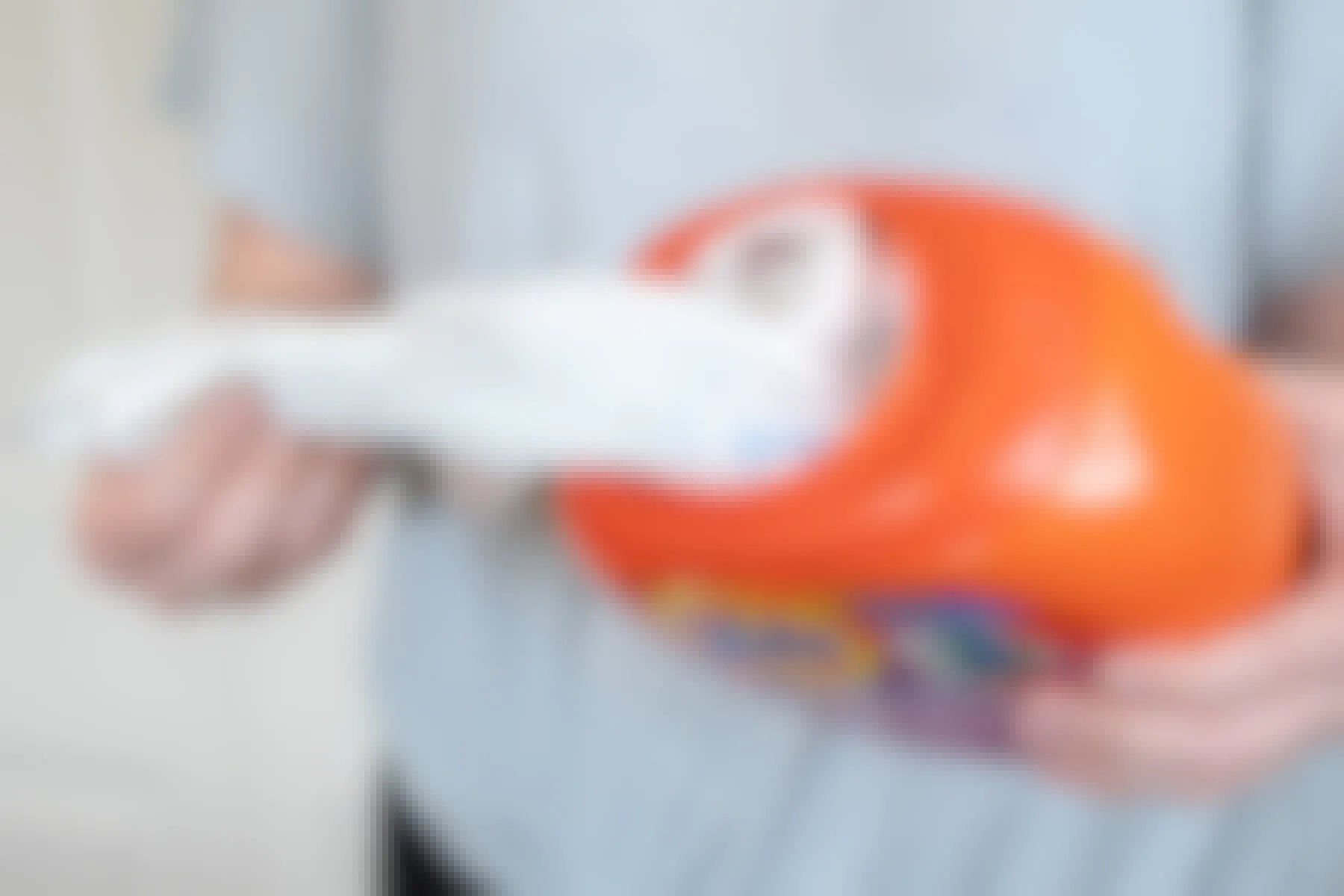 someone pulling plastic grocery bags out of a laundry detergent bottle