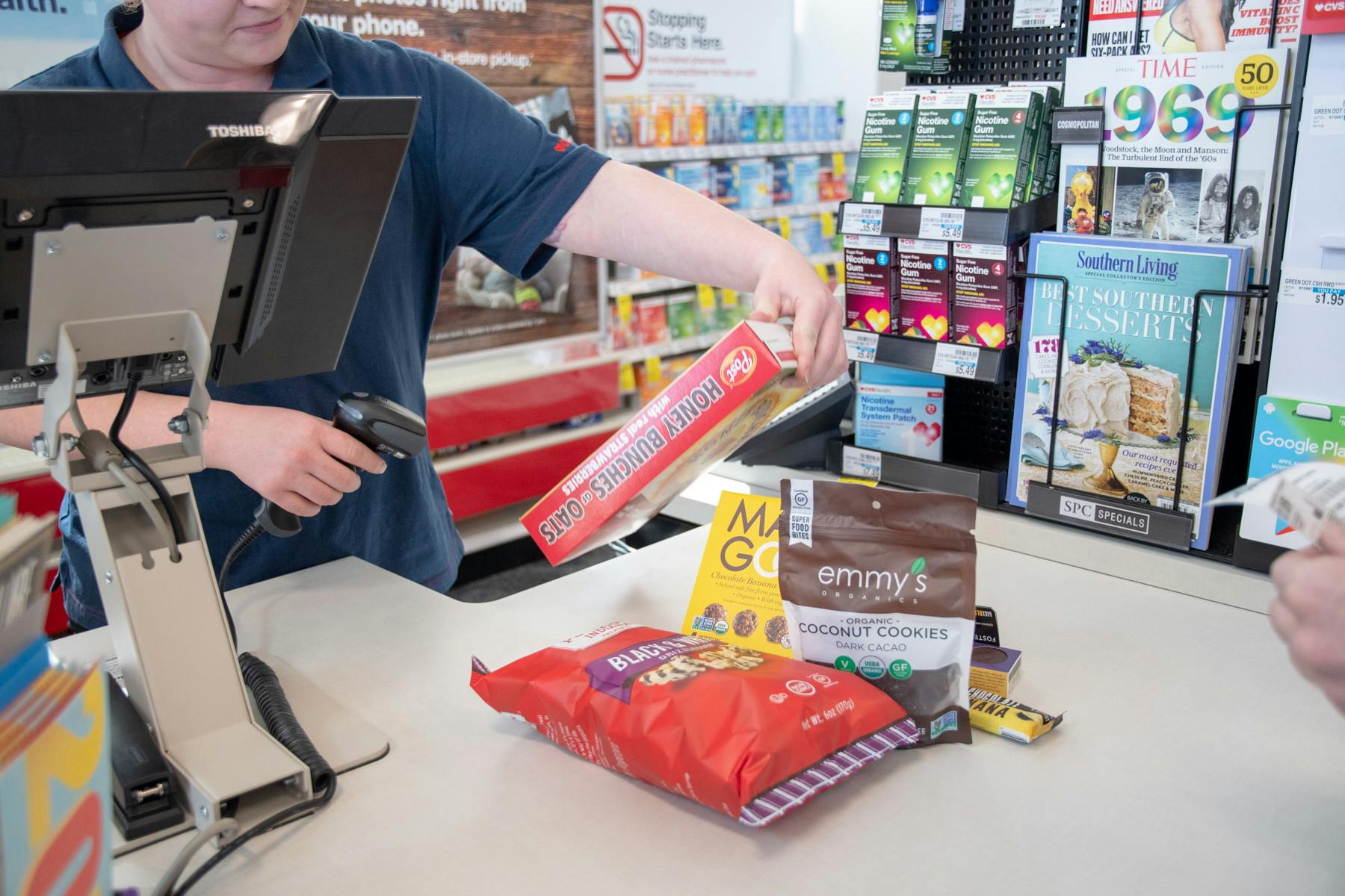 A CVS clerk scanning a product at the register in a CVS store.