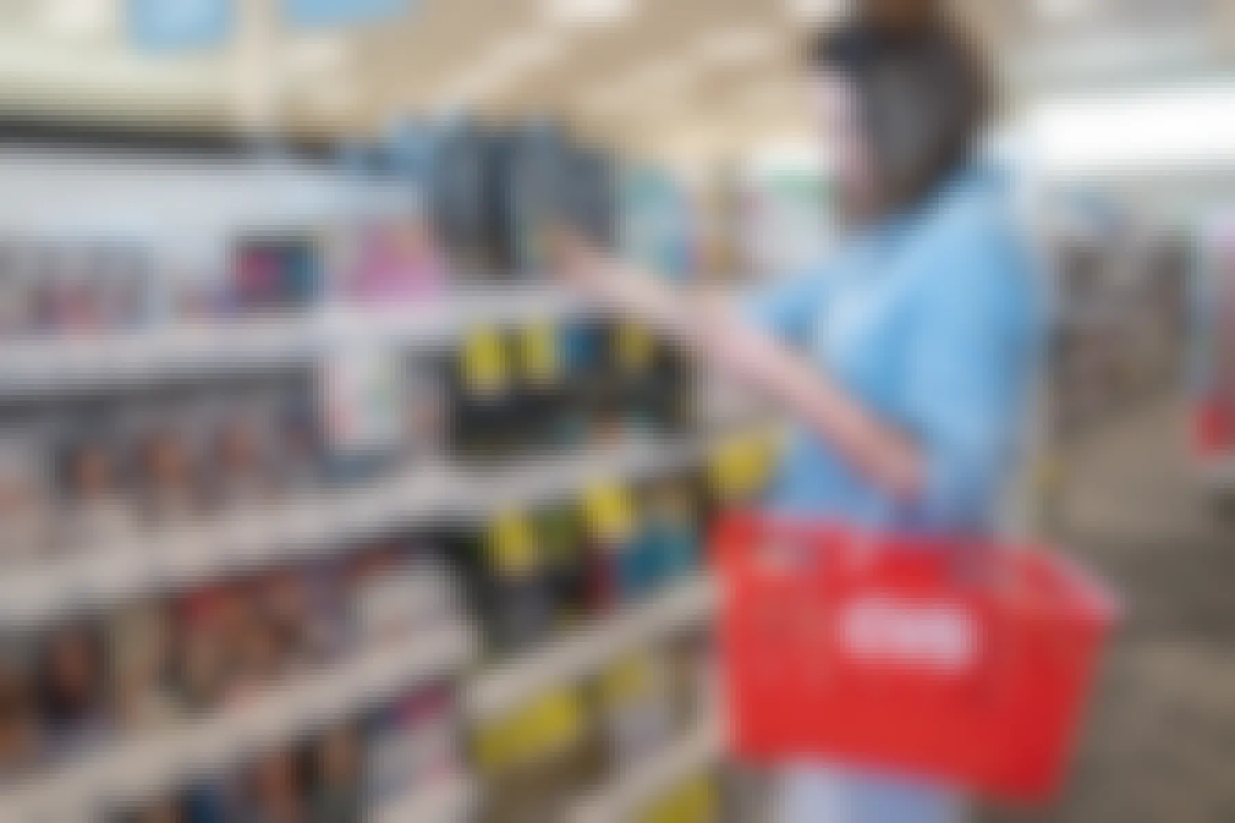 woman looking at phone while holding cvs basket
