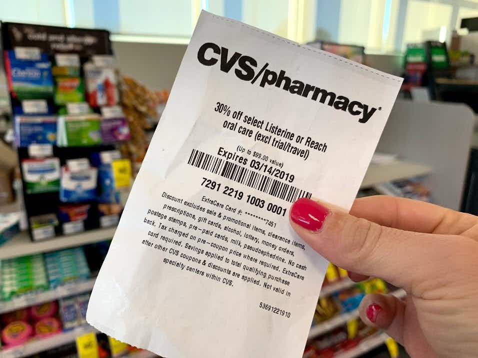 someone holding cvs coupon