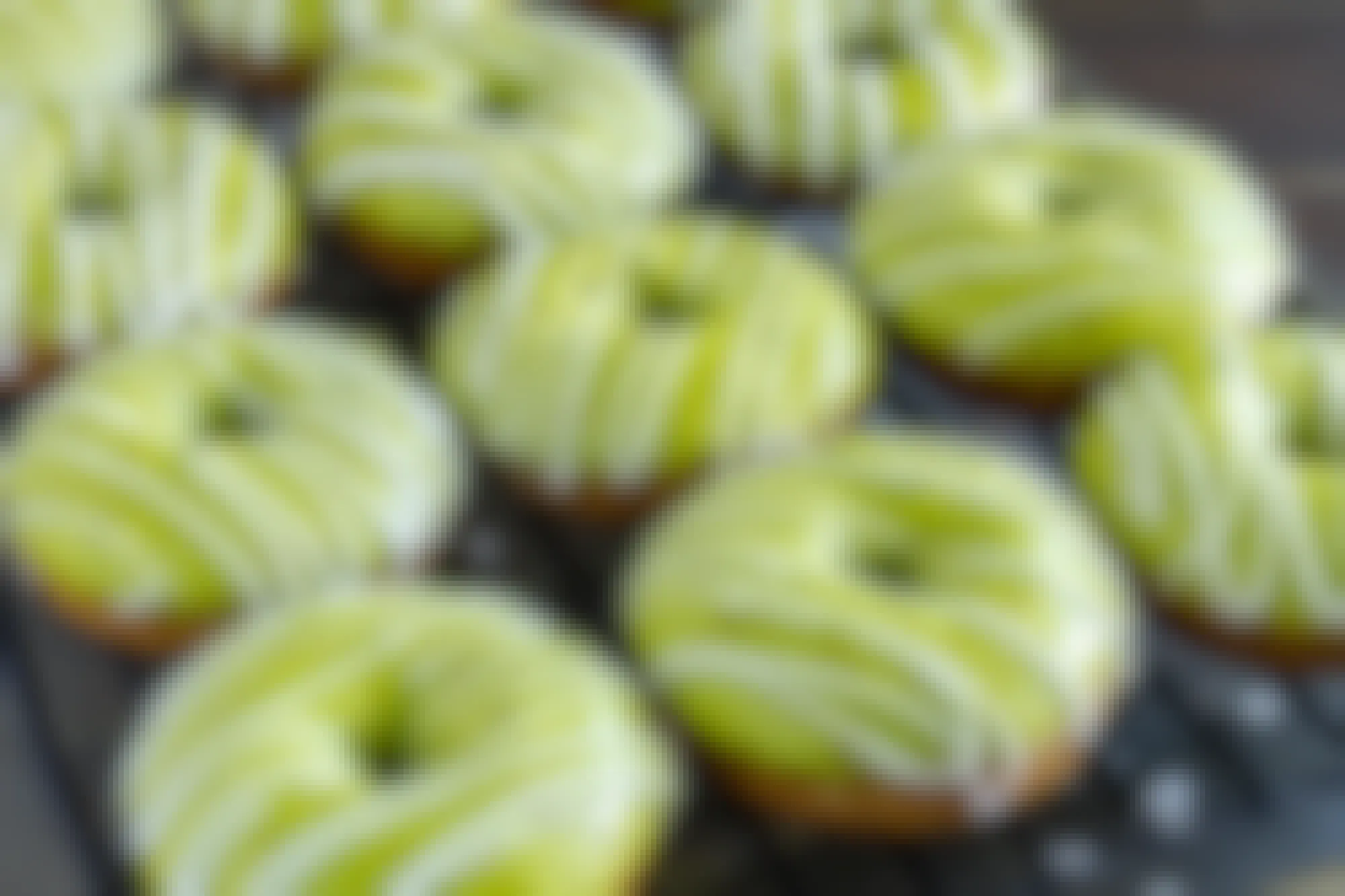 Doughnuts with green glaze on a cooling rack
