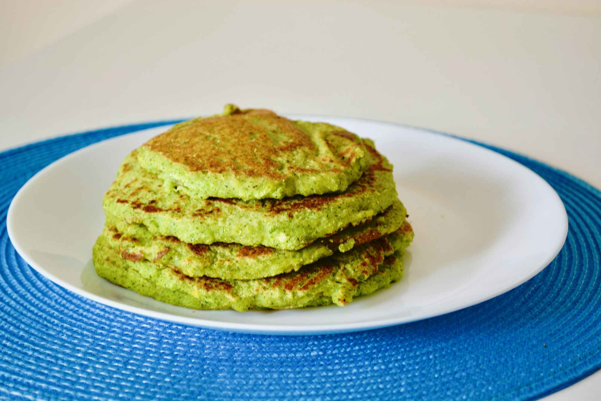A stack of green pancakes on a plate