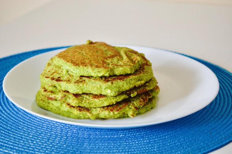 A stack of green pancakes on a plate
