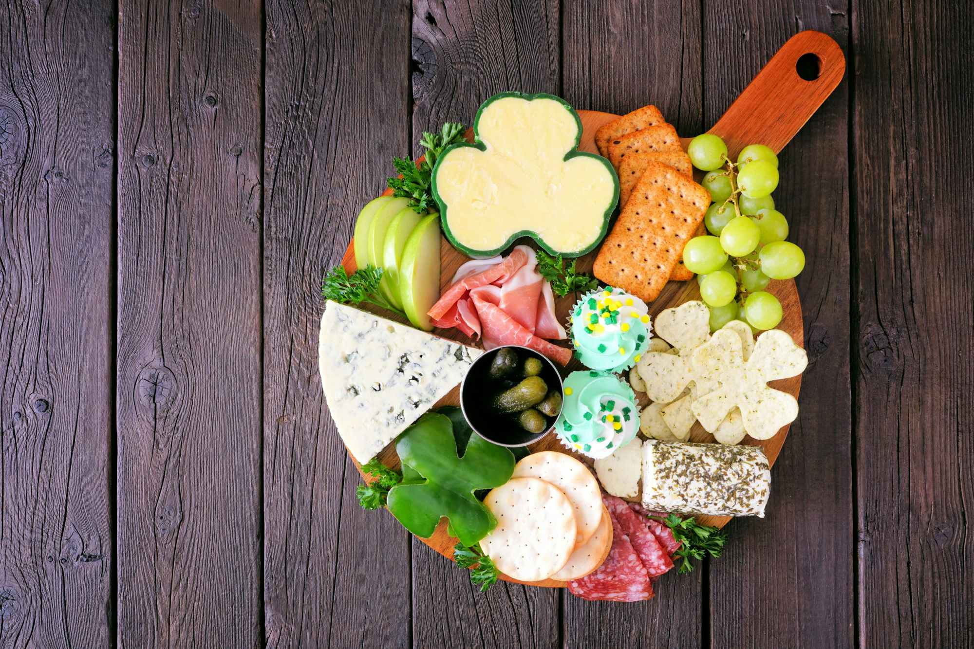 A charcuterie board with shamrock shaped snacks