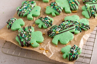 Some green Shamrock shaped cookies on a cooling rack