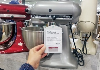 A woman looks at a 4.5 quart Kitchenaid mixer at Macys.